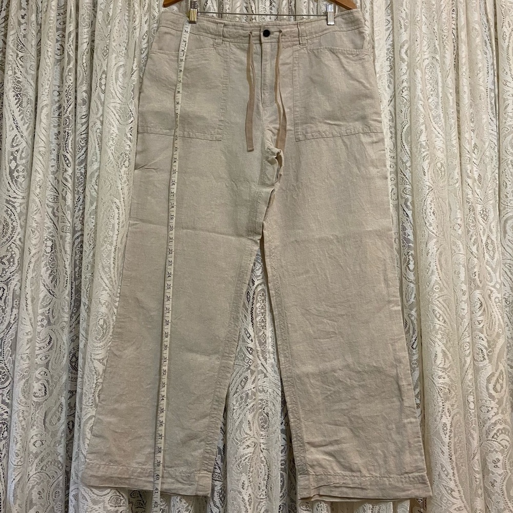 100 percent linen trousers. Button and zippered closure with tie at waist.